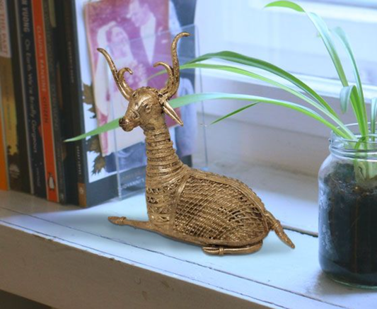BIG DOKRA BRASS SITTING DEER WITH NET DECORATION